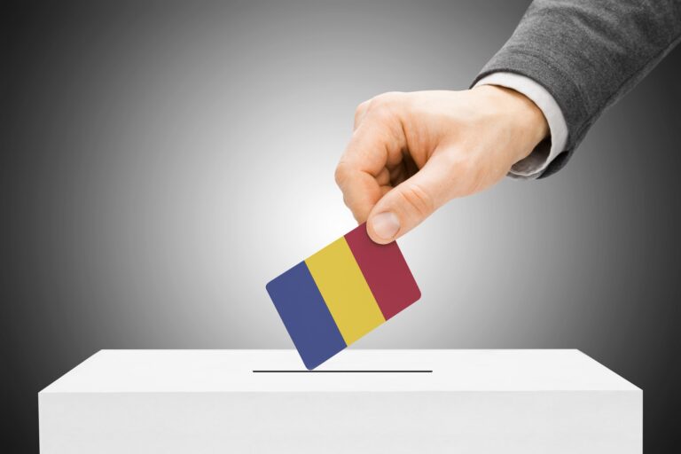 Voting concept - Male inserting flag into ballot box - Romania
